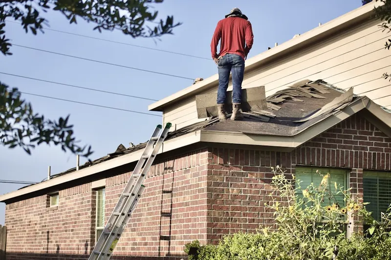 Professional roofer working on a residential roof in Port LaBelle